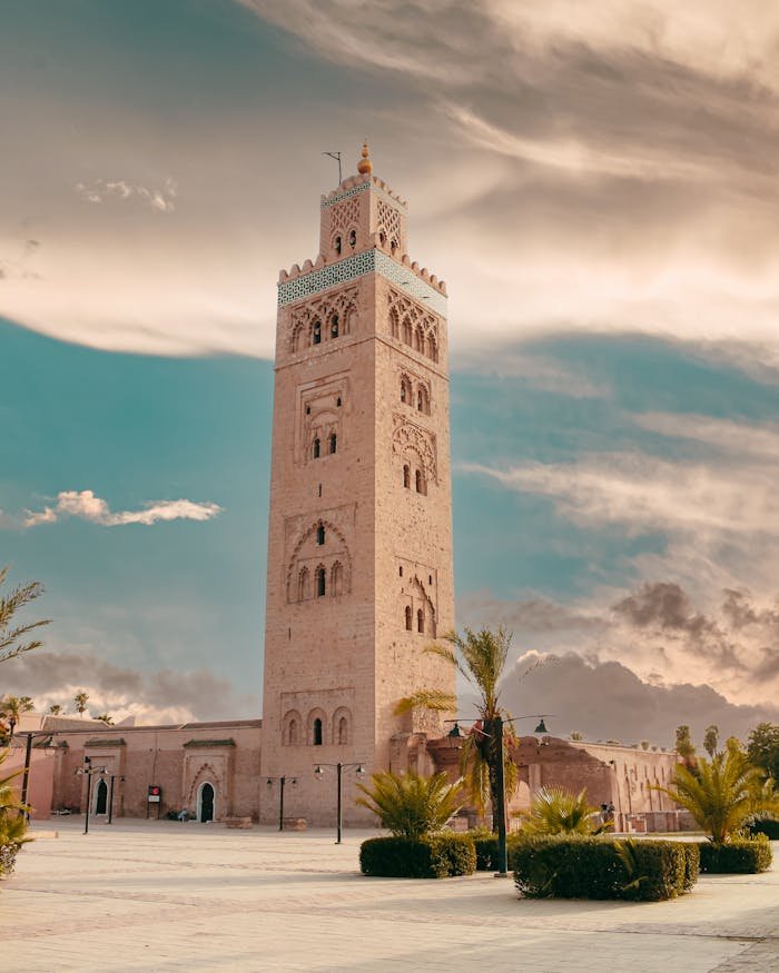 Majestic view of the Koutoubia Mosque tower, a landmark in Marrakech, Morocco under a dramatic sky.